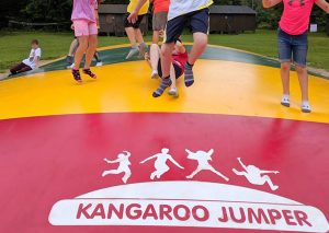 Kids jumping on a Kangaroo Jumper jumping pad.